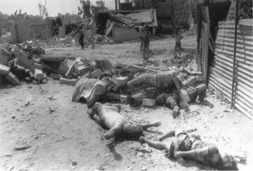 The bodies of Palestinian refugees killed in the massacre of civilians in the West Beirut refugee camp of Sabra lie amid the camp's rubble, Sept. 19, 1982 (STF/AFP/Getty Images)